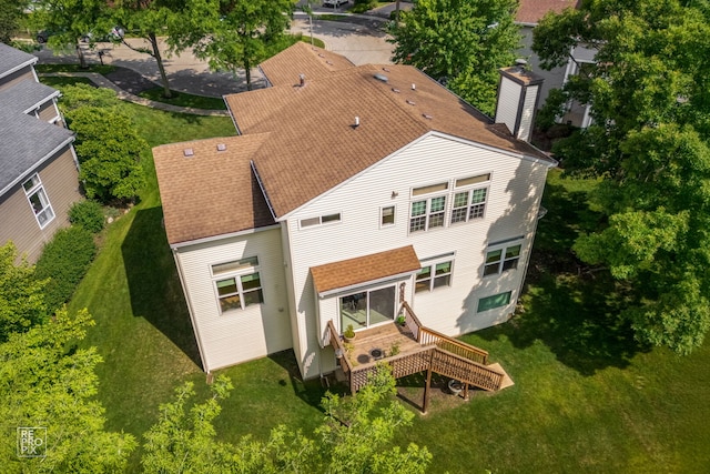 7623 Beringer Ct, Gurnee, IL 60031 - rear view of house with a shingled roof, a chimney, and a lawn