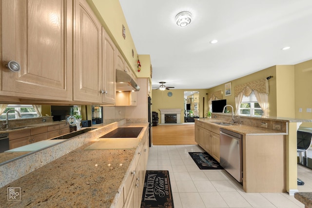 7623 Beringer Ct, Gurnee, IL 60031 - kitchen featuring light brown cabinets, stainless steel dishwasher, under cabinet range hood, a fireplace, and recessed lighting
