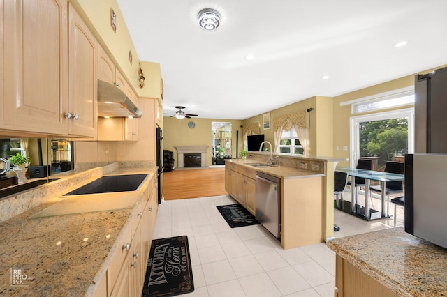 7623 Beringer Ct, Gurnee, IL 60031 - kitchen with black electric stovetop, light brown cabinetry, dishwasher, under cabinet range hood, and open floor plan