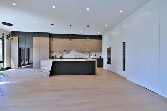 332 W Fremont Ave, Elmhurst, IL 60126 - kitchen featuring modern cabinets, light wood-type flooring, a large island, light countertops, and hanging light fixtures
