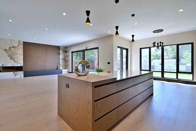 332 W Fremont Ave, Elmhurst, IL 60126 - kitchen featuring modern cabinets, a large island, light wood-style floors, open floor plan, and hanging light fixtures