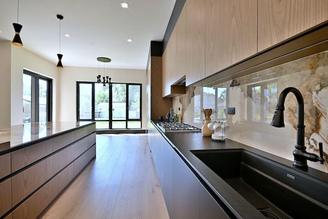 332 W Fremont Ave, Elmhurst, IL 60126 - kitchen with stainless steel gas cooktop, modern cabinets, decorative light fixtures, light wood-style flooring, and recessed lighting