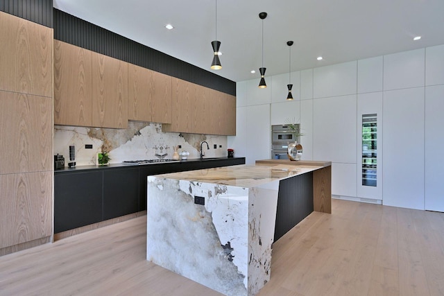 332 W Fremont Ave, Elmhurst, IL 60126 - kitchen with modern cabinets, decorative backsplash, light wood-style floors, stainless steel appliances, and recessed lighting