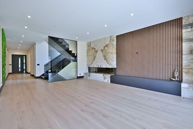 332 W Fremont Ave, Elmhurst, IL 60126 - unfurnished living room featuring stairs, recessed lighting, wood finished floors, and a high end fireplace