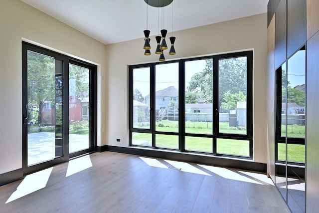 332 W Fremont Ave, Elmhurst, IL 60126 - doorway featuring wood finished floors, a chandelier, and plenty of natural light