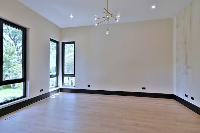 332 W Fremont Ave, Elmhurst, IL 60126 - empty room featuring healthy amount of natural light, wood finished floors, a chandelier, and recessed lighting