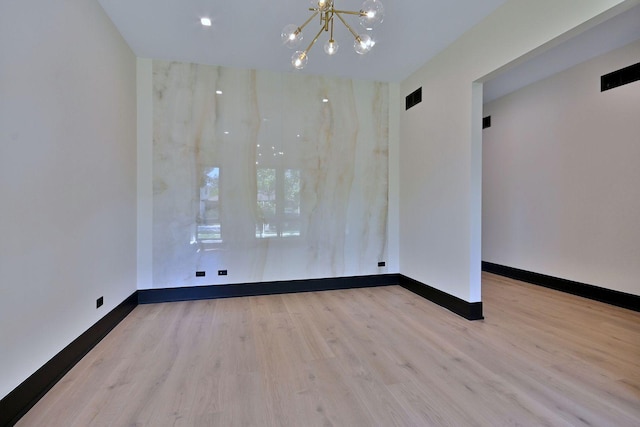 332 W Fremont Ave, Elmhurst, IL 60126 - unfurnished room featuring a chandelier and wood finished floors