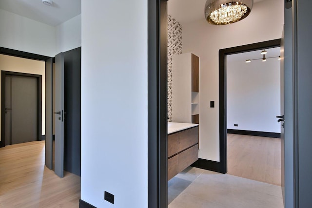 332 W Fremont Ave, Elmhurst, IL 60126 - corridor featuring a chandelier and light wood finished floors