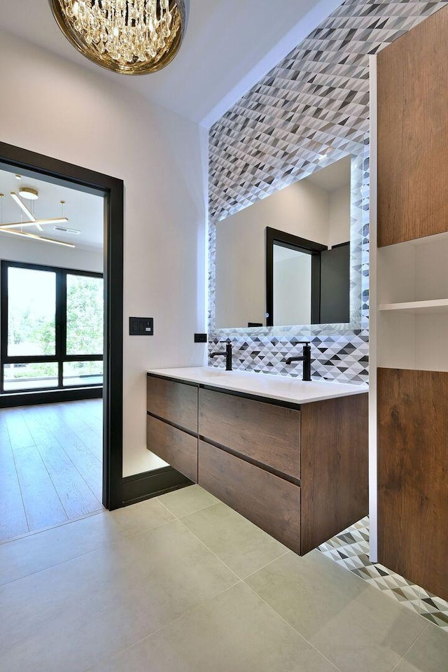 332 W Fremont Ave, Elmhurst, IL 60126 - bathroom featuring a chandelier, double vanity, and tasteful backsplash