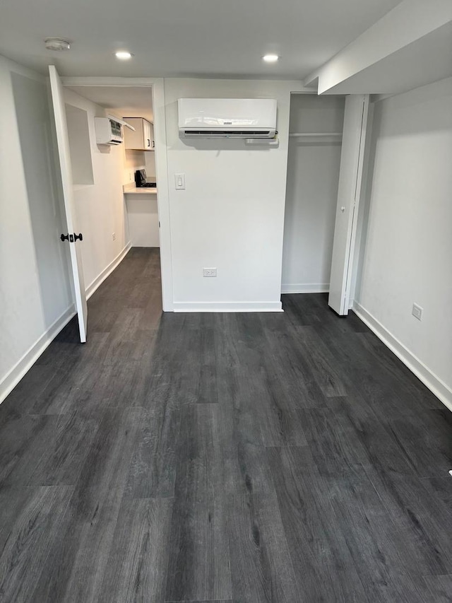 1422 N Latrobe Ave, Chicago, IL 60651 - unfurnished bedroom featuring a wall mounted air conditioner, dark wood-style flooring, a wall unit AC, baseboards, and recessed lighting
