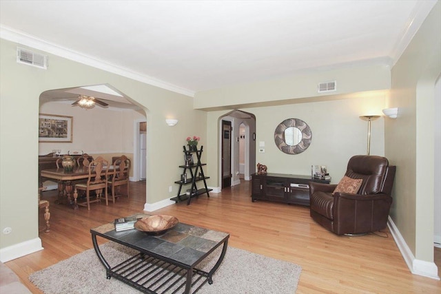 43 N Park Ave Unit 1A, Lombard, IL 60148 - living area with arched walkways, light wood-style flooring, ornamental molding, and a ceiling fan