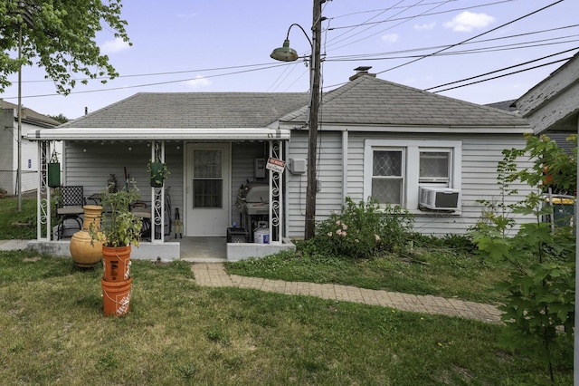 6513 Kane Ave, Hodgkins, IL 60525 - view of front of property featuring cooling unit, a front lawn, and roof with shingles