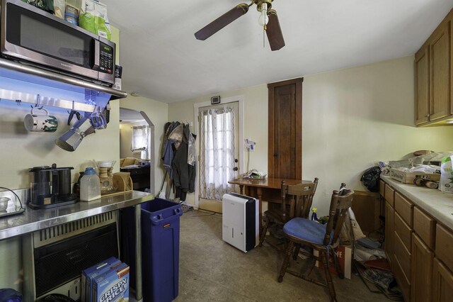 6513 Kane Ave, Hodgkins, IL 60525 - kitchen featuring stainless steel microwave, ceiling fan, arched walkways, and light countertops