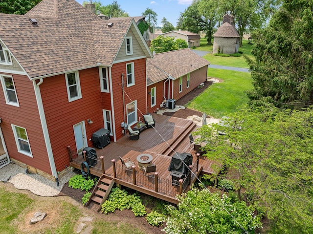 12002 Patterson Rd, Durand, IL 61024 - rear view of property with a deck, roof with shingles, a lawn, and a fire pit