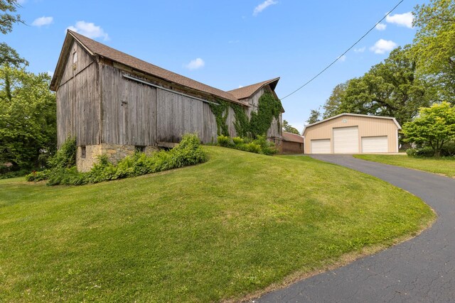 12002 Patterson Rd, Durand, IL 61024 - view of property exterior with a garage, an outdoor structure, and a yard