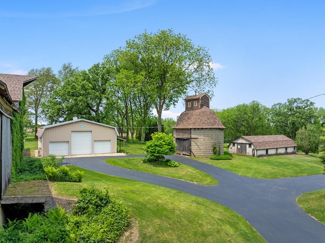 12002 Patterson Rd, Durand, IL 61024 - view of property's community featuring a detached garage, a yard, and an outbuilding