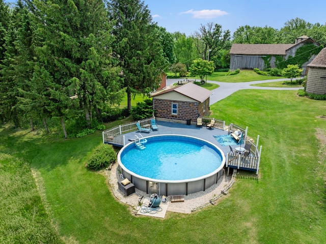 12002 Patterson Rd, Durand, IL 61024 - outdoor pool featuring a wooden deck and a lawn