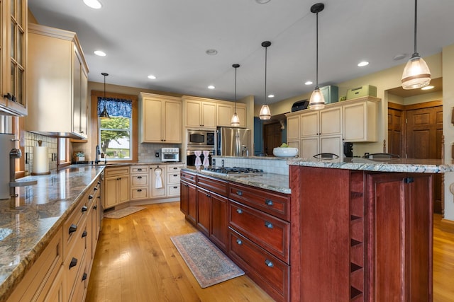 12002 Patterson Rd, Durand, IL 61024 - kitchen with appliances with stainless steel finishes, cream cabinets, light wood-style flooring, backsplash, and glass insert cabinets