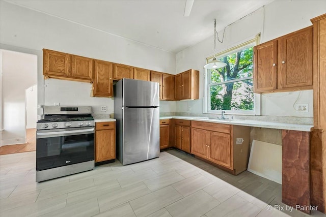 18 Madison St, Algonquin, IL 60102 - kitchen featuring stainless steel appliances, brown cabinets, light countertops, and pendant lighting