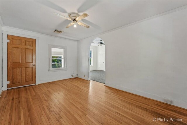 18 Madison St, Algonquin, IL 60102 - spare room with a ceiling fan, light wood-type flooring, ornamental molding, and arched walkways