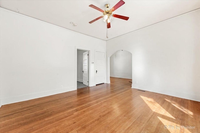18 Madison St, Algonquin, IL 60102 - spare room featuring arched walkways, a ceiling fan, and light wood-style flooring