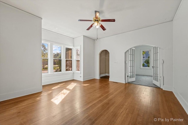 18 Madison St, Algonquin, IL 60102 - spare room featuring arched walkways, french doors, a ceiling fan, and wood-type flooring