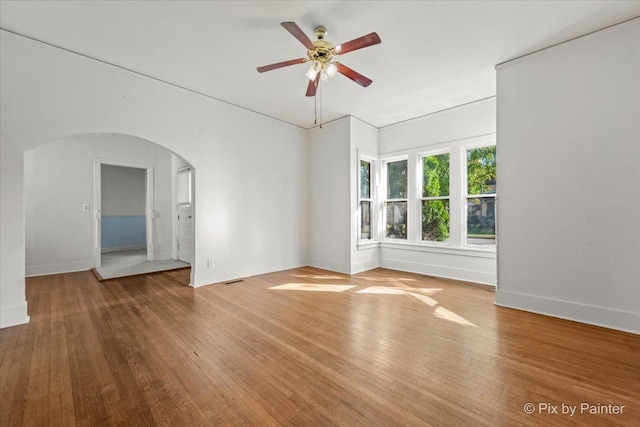 18 Madison St, Algonquin, IL 60102 - spare room with arched walkways, ceiling fan, and wood finished floors