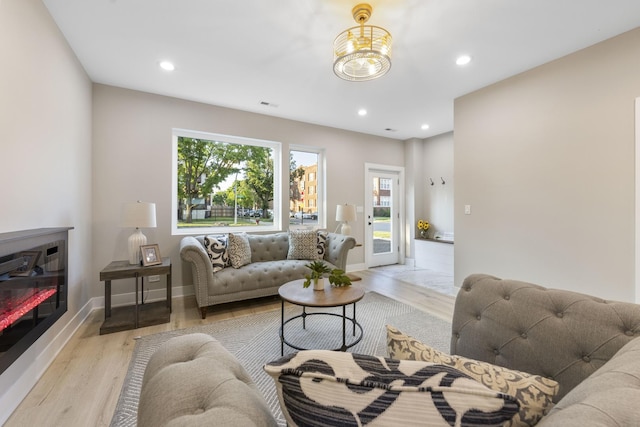 5901 W Erie St, Chicago, IL 60644 - living area featuring light wood-style flooring, recessed lighting, and baseboards