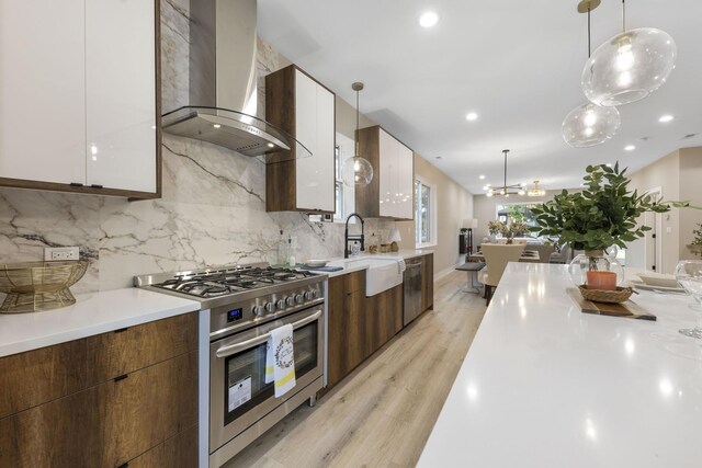 5901 W Erie St, Chicago, IL 60644 - kitchen featuring stainless steel appliances, wall chimney exhaust hood, modern cabinets, and recessed lighting