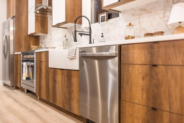 5901 W Erie St, Chicago, IL 60644 - kitchen with stainless steel appliances, modern cabinets, and brown cabinetry