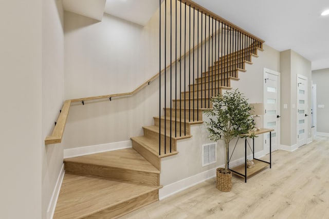 5901 W Erie St, Chicago, IL 60644 - stairs featuring wood finished floors, baseboards, and recessed lighting