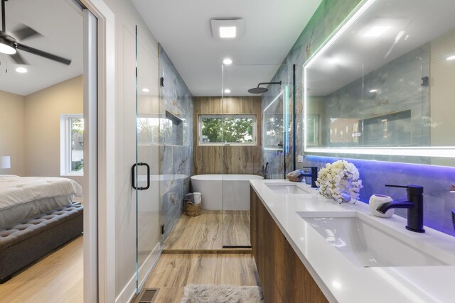 5901 W Erie St, Chicago, IL 60644 - full bath featuring a shower stall, double vanity, a freestanding tub, wood finished floors, and ceiling fan