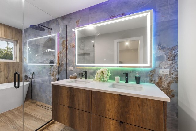 5901 W Erie St, Chicago, IL 60644 - full bathroom with tile walls, double vanity, a freestanding tub, and walk in shower