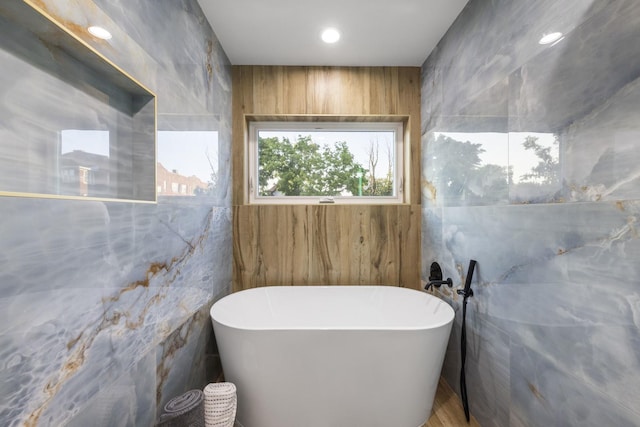 5901 W Erie St, Chicago, IL 60644 - full bath featuring a freestanding tub, tile walls, and recessed lighting