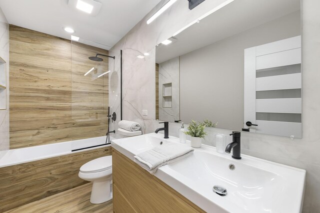 5901 W Erie St, Chicago, IL 60644 - full bath with bathtub / shower combination, toilet, double vanity, and wood finished floors