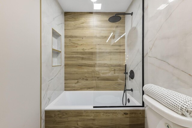5901 W Erie St, Chicago, IL 60644 - full bathroom featuring a combined bath / shower with marble appearance and toilet