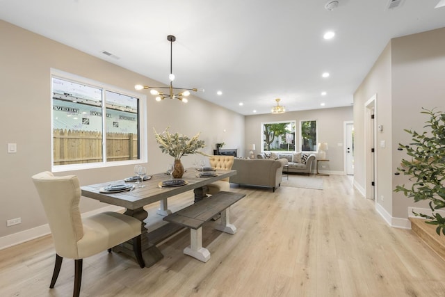 5901 W Erie St, Chicago, IL 60644 - dining room featuring a chandelier, light wood finished floors, recessed lighting, and baseboards