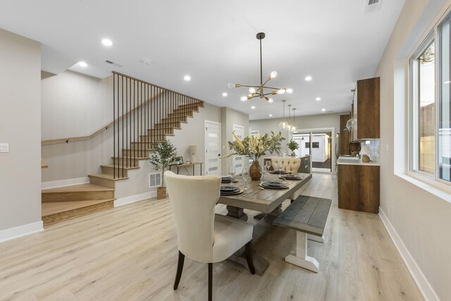 5901 W Erie St, Chicago, IL 60644 - dining area featuring a chandelier, stairs, light wood-style floors, baseboards, and recessed lighting