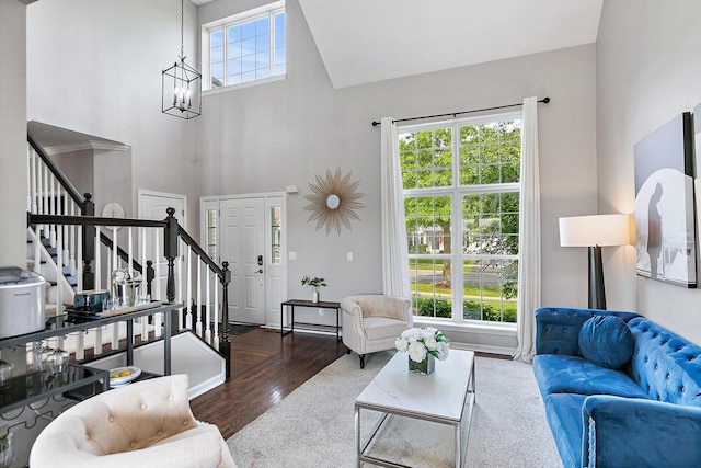 1S215 S Hyde Park, Geneva, IL 60134 - living room featuring stairs, wood finished floors, a high ceiling, and a chandelier