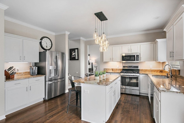 1S215 S Hyde Park, Geneva, IL 60134 - kitchen featuring appliances with stainless steel finishes, dark wood finished floors, crown molding, white cabinets, and a kitchen island