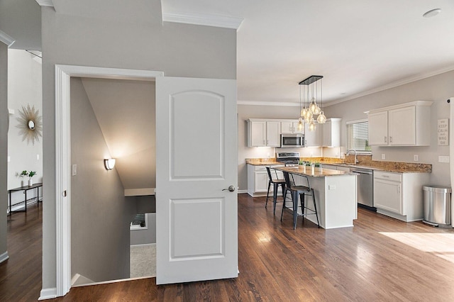 1S215 S Hyde Park, Geneva, IL 60134 - kitchen with appliances with stainless steel finishes, a kitchen breakfast bar, dark wood finished floors, white cabinets, and crown molding