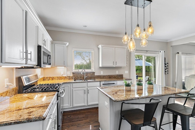 1S215 S Hyde Park, Geneva, IL 60134 - kitchen with appliances with stainless steel finishes, a breakfast bar area, light stone counters, white cabinets, and ornamental molding