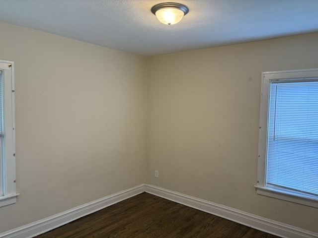 1101 N Ash St, Waukegan, IL 60085 - spare room featuring dark wood-style floors and healthy amount of natural light