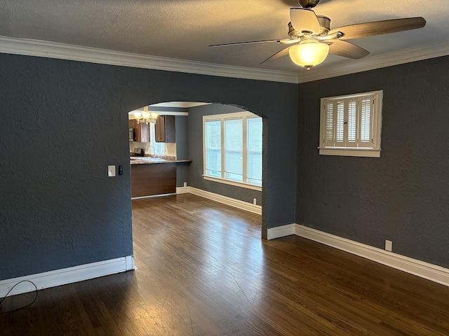 1101 N Ash St, Waukegan, IL 60085 - unfurnished living room featuring arched walkways, dark wood finished floors, ceiling fan, a textured wall, and crown molding