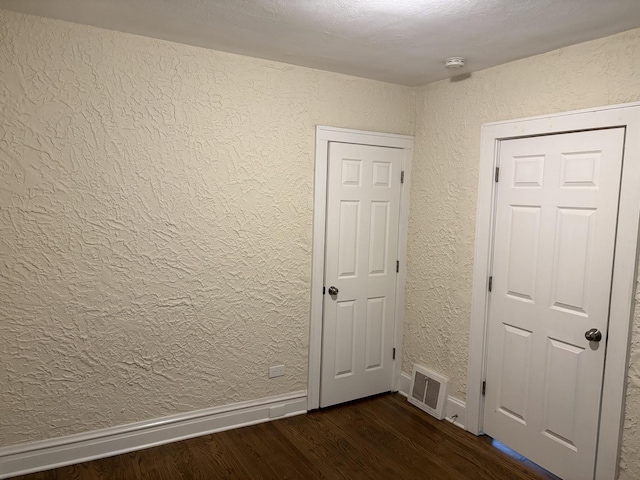 1101 N Ash St, Waukegan, IL 60085 - empty room with dark wood-style floors and a textured wall