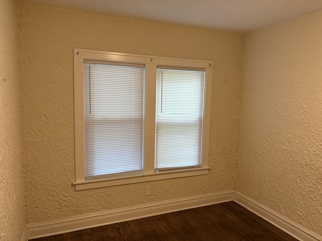 1101 N Ash St, Waukegan, IL 60085 - empty room with dark wood-type flooring and a textured wall