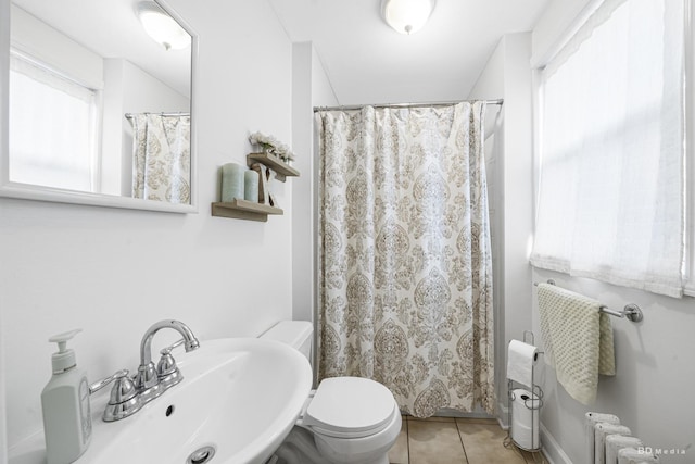 5213 Fairview Ave, Downers Grove, IL 60515 - bathroom featuring radiator heating unit, tile patterned flooring, toilet, a sink, and a shower with curtain