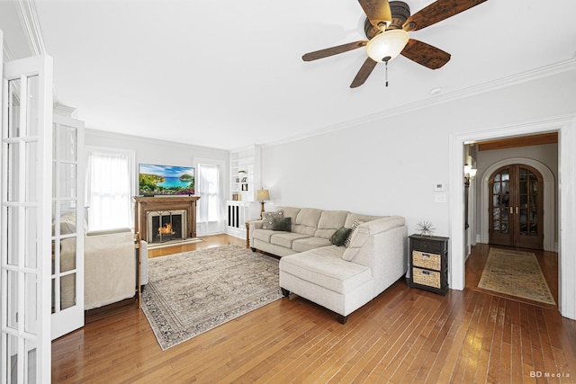 5213 Fairview Ave, Downers Grove, IL 60515 - living room with french doors, crown molding, hardwood / wood-style floors, a warm lit fireplace, and a ceiling fan