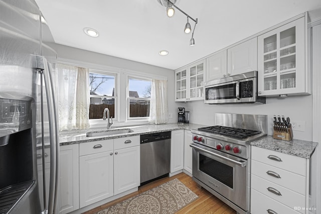 5213 Fairview Ave, Downers Grove, IL 60515 - kitchen featuring stainless steel appliances, a sink, light wood finished floors, white cabinets, and glass insert cabinets