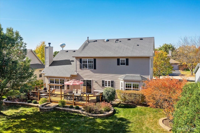 439 Camden Cir, Oswego, IL 60543 - back of house featuring a chimney, a lawn, a wooden deck, and a shingled roof